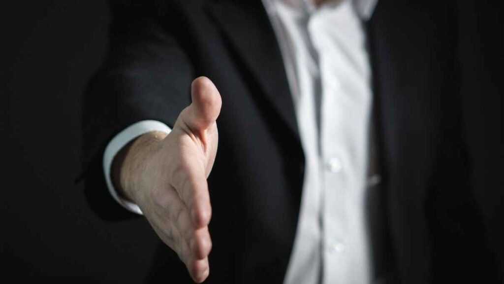 Professional offering a handshake representing successful affiliate marketing partnerships