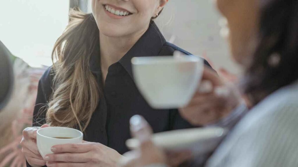 Enjoying coffee at home with friends to save money