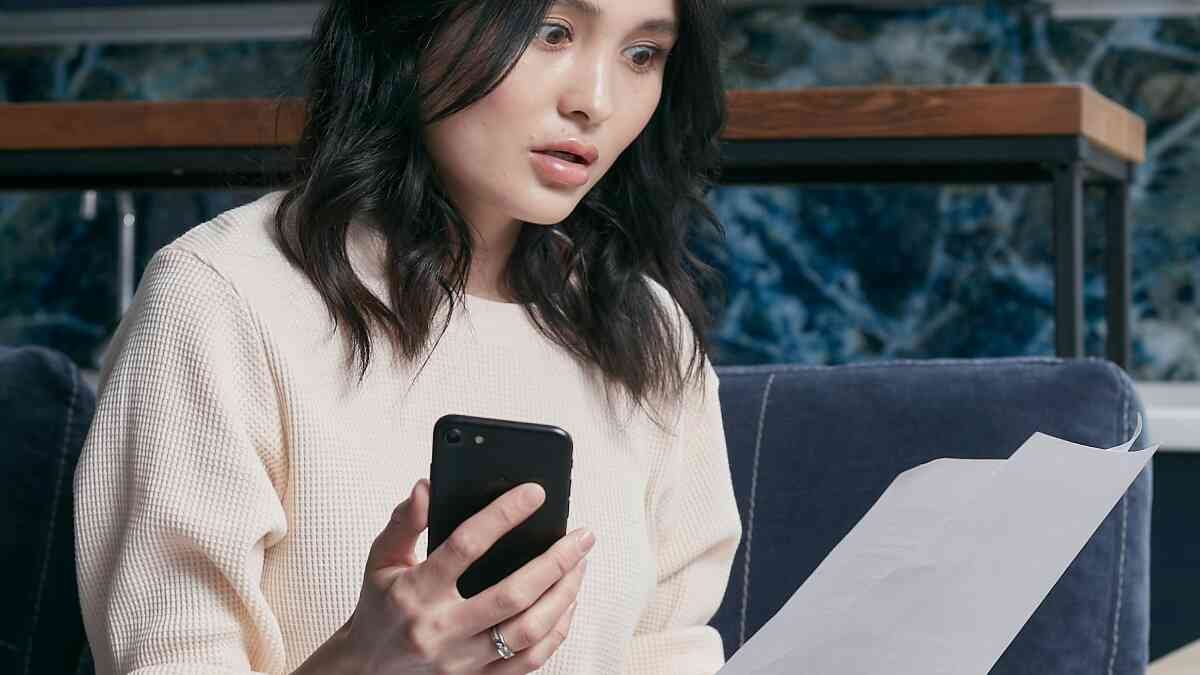 Stressed person looking at pile of bills wondering how to get out of debt with no money